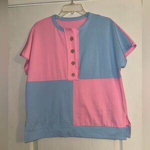 Pink and blue patchwork style top with brown buttons and side slits. Oversized
